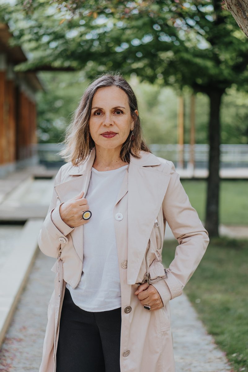 Portrait of Tamara Medina Sapovalova in a beige coat, outdoors